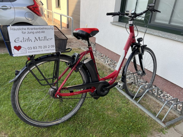 Fahrrad mit Firmenschild vor dem Büro der Häuslichen Krankenbetrrung Edith Müller GmbH
